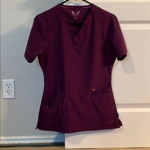 Smitten XS scrubs in Eggplant with pink accents.